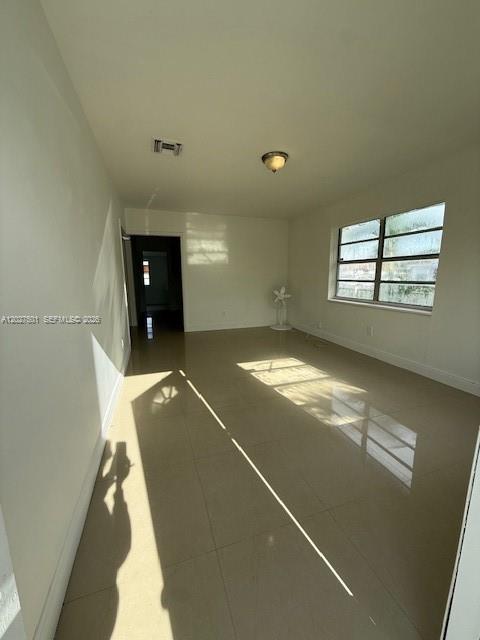 An empty room with light-colored tile flooring, white walls, and a window with blinds — 3700 SW 56TH AVE # 3700, West Park FL 33023, WEST PARK, FL