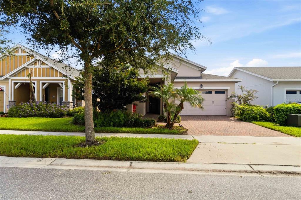 A single-story house with a paved driveway, a two-car garage, and a front yard — 5023 SUNFALLS AVENUE, ST CLOUD, FL