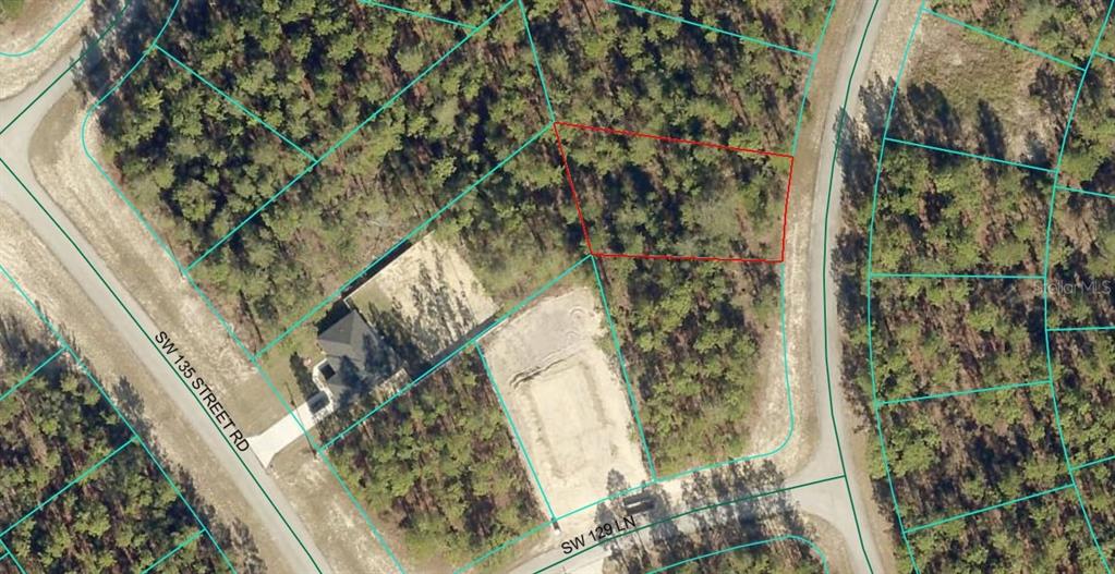 An aerial view shows a vacant, wooded residential lot outlined in red — TBD SW 84TH TERRACE ROAD, OCALA, FL