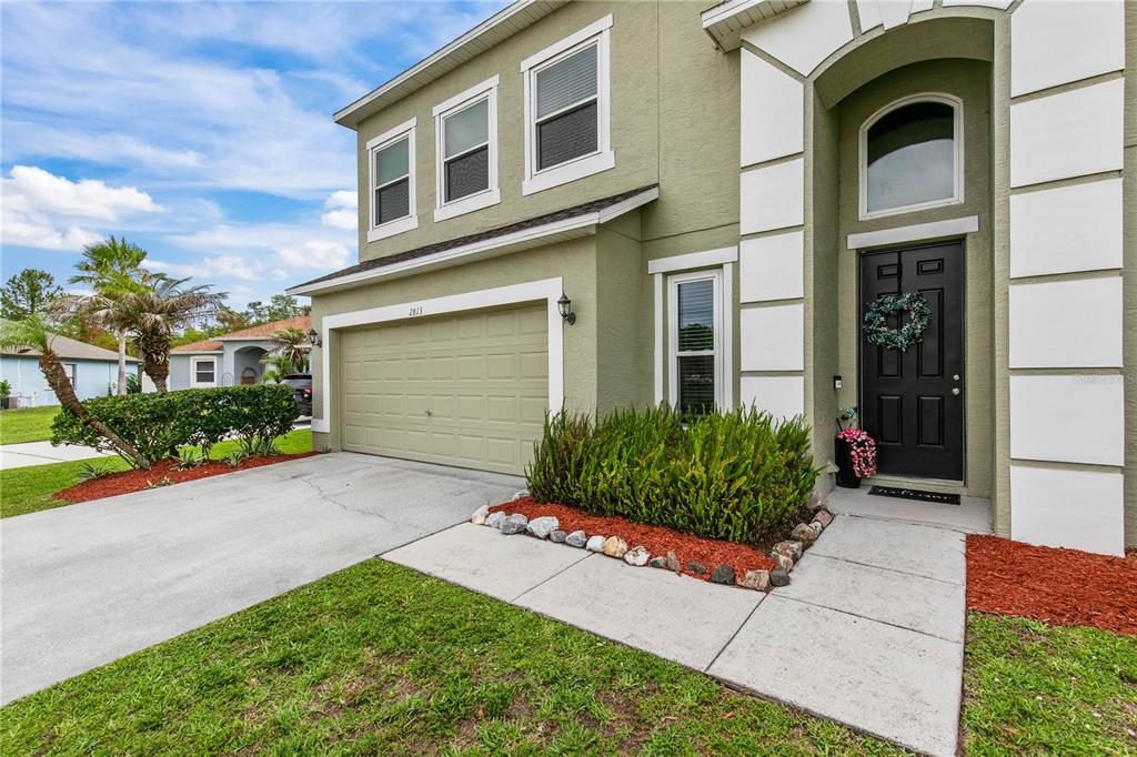 A kitchen island with granite countertops sits in an open-concept living area with tile floors — 2813 VILLAGE PINE TERRACE, ORLANDO, FL