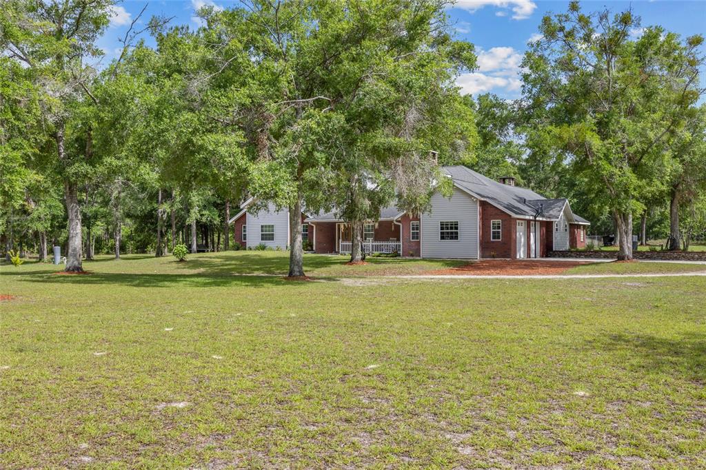 A single-story house with brick and siding exterior, a front porch, and two dormer windows — 1827 SW SHILOH STREET, FORT WHITE, FL