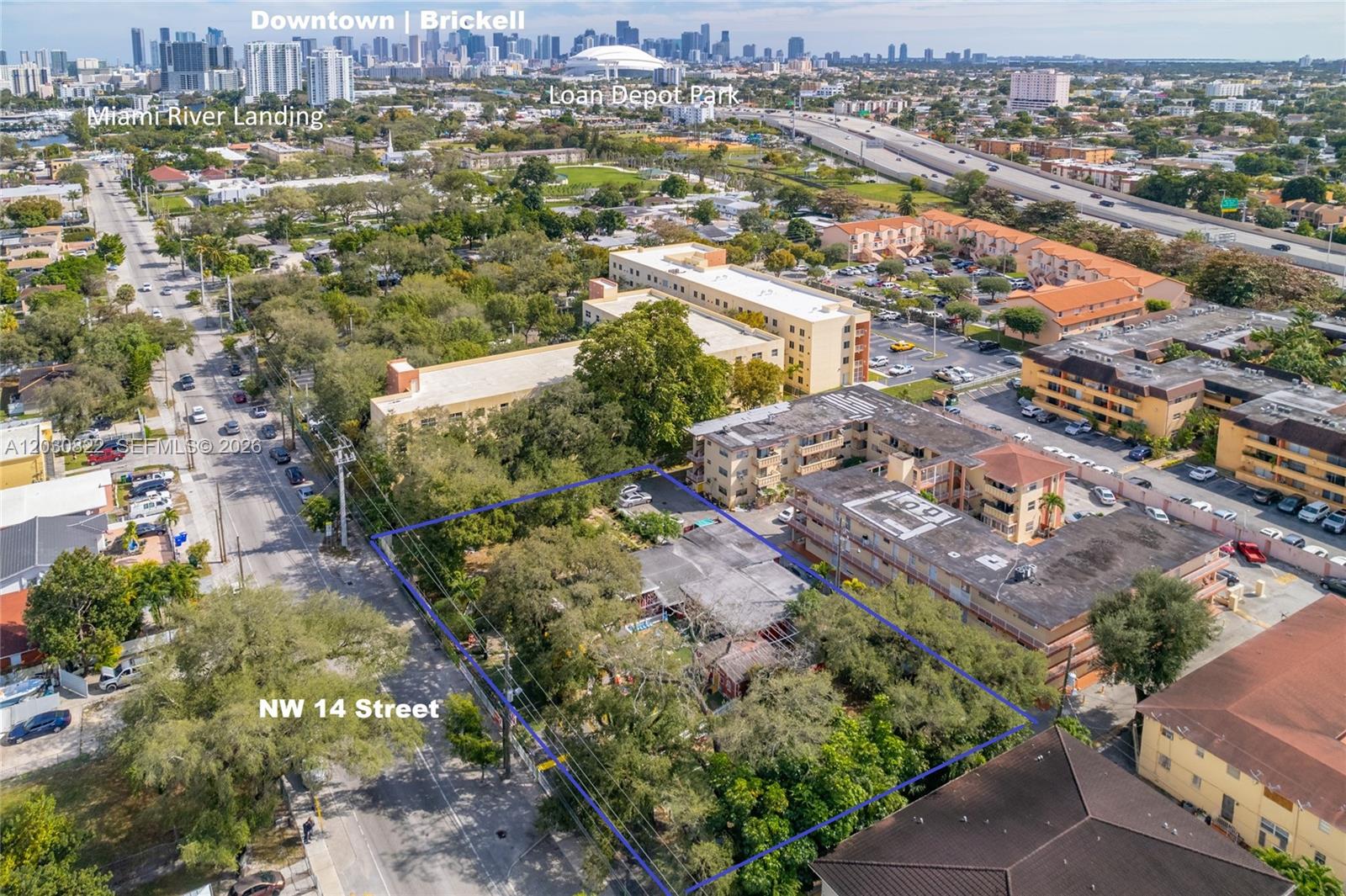 An aerial view shows a rectangular plot of land outlined in blue near a street — 2470 NW 14th St, Miami FL 33125, MIAMI, FL