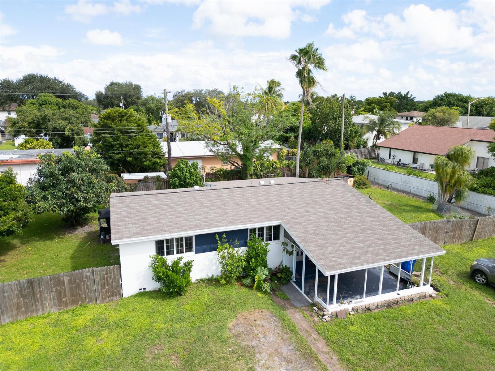 An aerial view of a single-story house with a shingled roof and a screened porch — 2011 SW 97th Terrace, Miramar FL 33025, MIRAMAR, FL