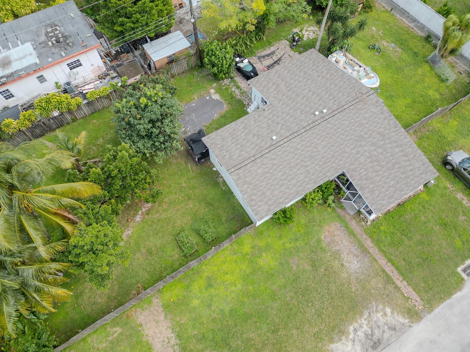 An aerial view shows a single-story house with a shingled roof, yard, and driveway — 2011 SW 97th Terrace, Miramar FL 33025, MIRAMAR, FL