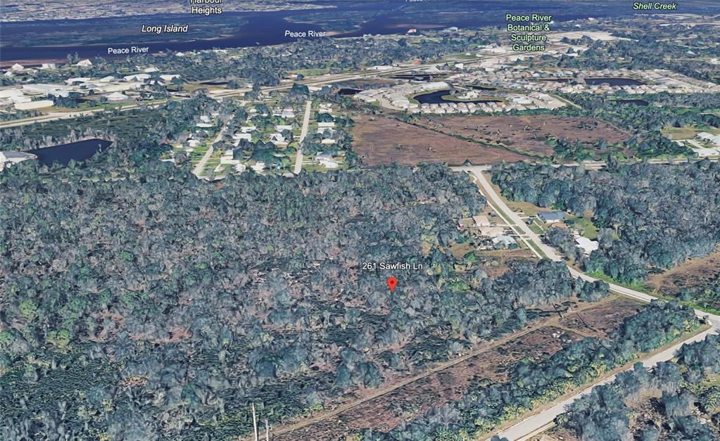 This aerial map view shows a wooded residential lot located near the Peace River — 261 SAWFISH LANE, PUNTA GORDA, FL