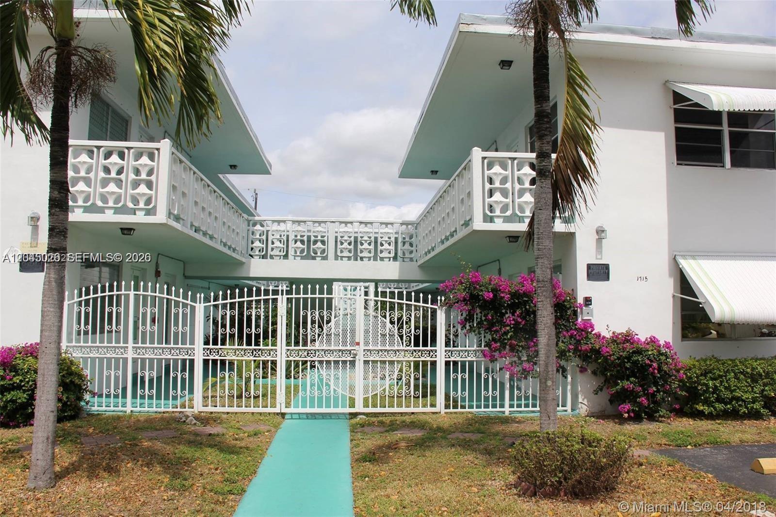 A two-story apartment building features white railings, a gated courtyard, and a turquoise walkway — 1715 Wiley St # 5, Hollywood FL 33020, HOLLYWOOD, FL