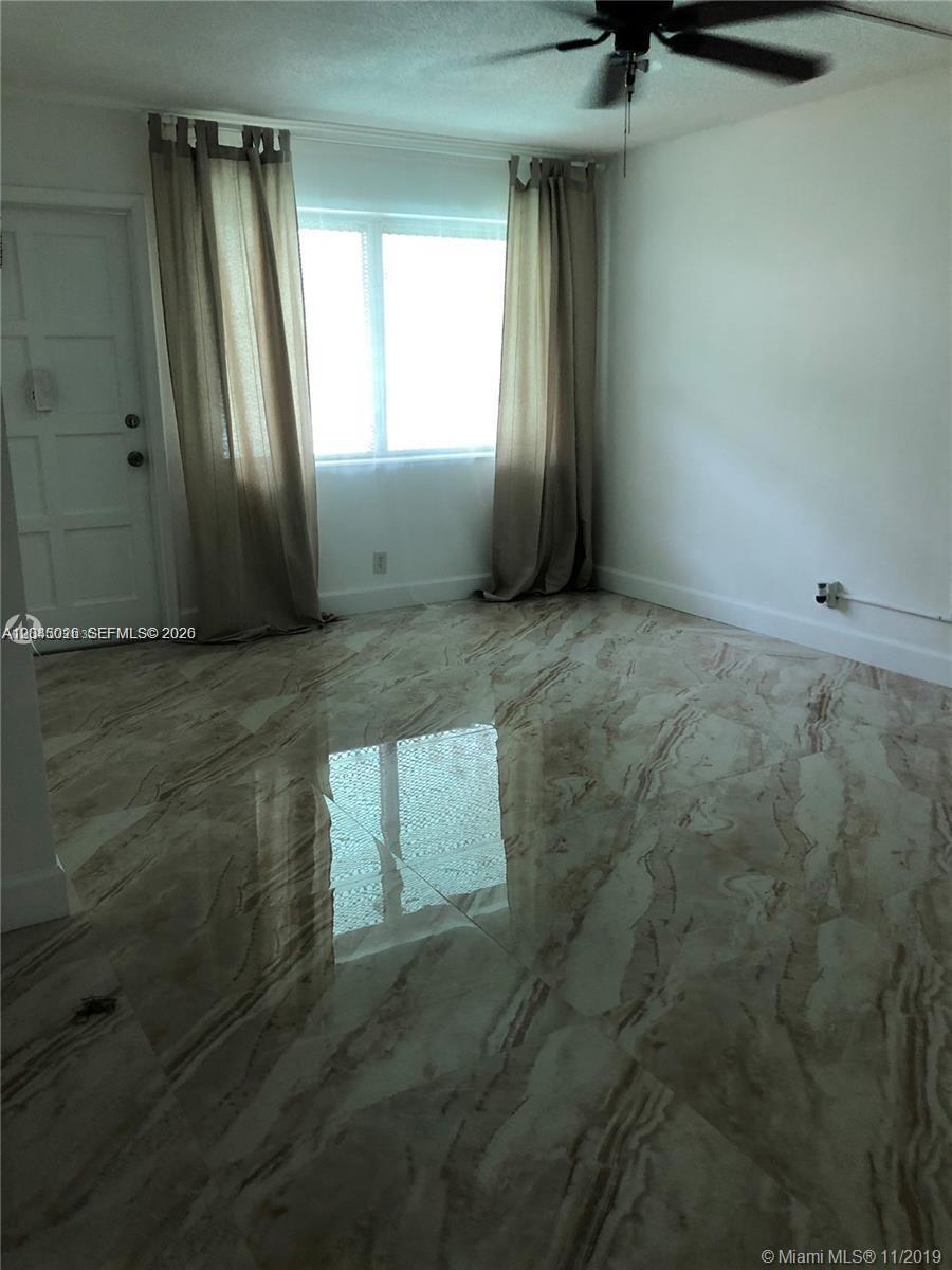 A room with white walls, a ceiling fan, and polished marble-look tile flooring — 1715 Wiley St # 5, Hollywood FL 33020, HOLLYWOOD, FL