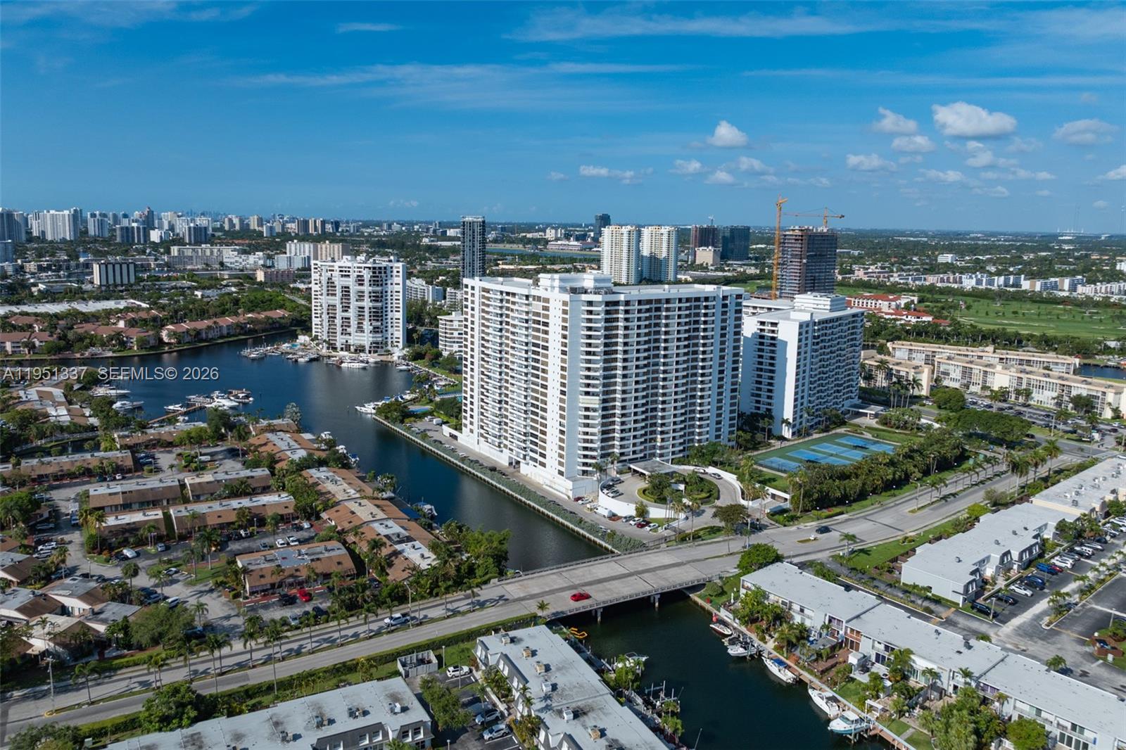 An aerial view shows high-rise apartment buildings situated along a canal with boat slips — 2500 Parkview Dr # 2517, Hallandale Beach FL 33009, HALLANDALE BEACH, FL