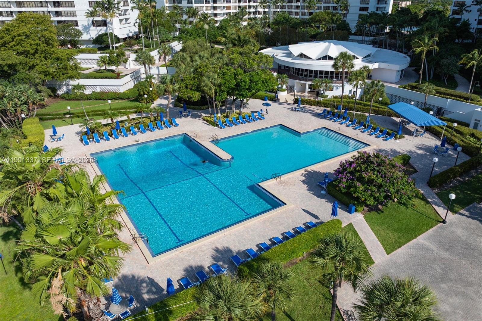 An aerial view shows a large L-shaped swimming pool surrounded by lounge chairs and landscaping — 2500 Parkview Dr # 2517, Hallandale Beach FL 33009, HALLANDALE BEACH, FL