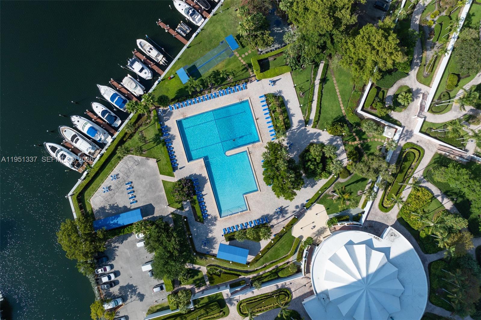 An aerial view shows a swimming pool, boat slips, parking lot, and landscaped grounds — 2500 Parkview Dr # 2517, Hallandale Beach FL 33009, HALLANDALE BEACH, FL