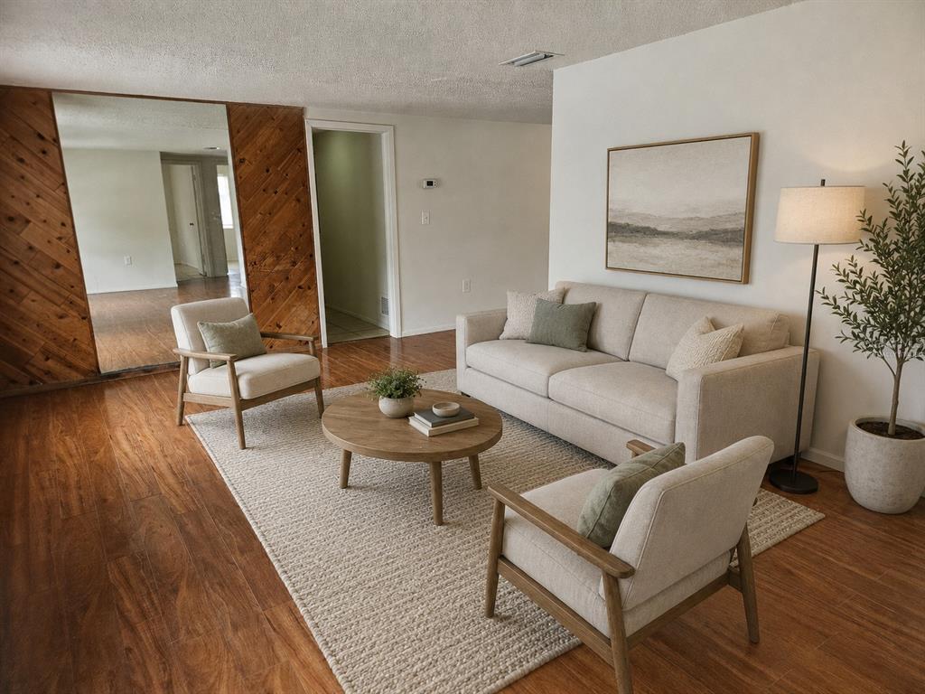 A living room features a beige sofa, two armchairs, a round coffee table, and wood paneling — 6945 TWILITE DRIVE, PORT RICHEY, FL