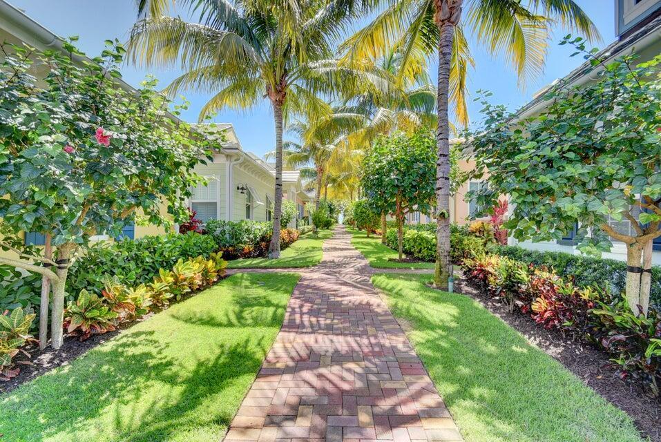A brick walkway leads between two residential buildings lined with palm trees and tropical landscaping — 2225 S Ocean Boulevard # a, Delray Beach FL 33483, DELRAY BEACH, FL
