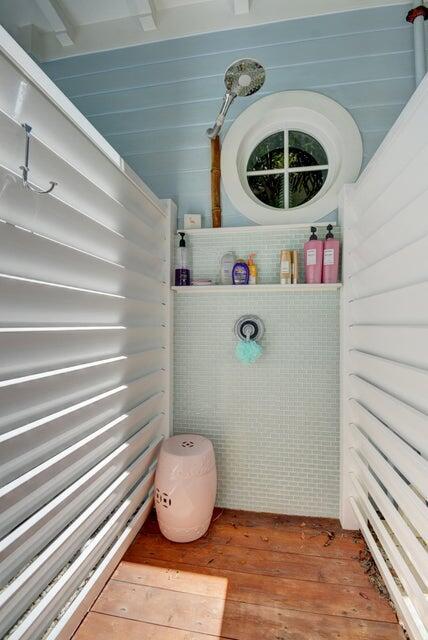 An outdoor shower features white louvered walls, a round window, and light blue tiled walls — 2225 S Ocean Boulevard # a, Delray Beach FL 33483, DELRAY BEACH, FL