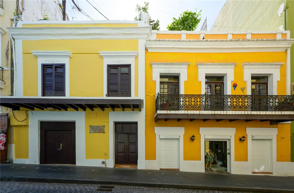 A two-story yellow building with a balcony and dark wooden doors on a cobblestone street — 255 SAN JUSTO STREET, SAN JUAN, PR
