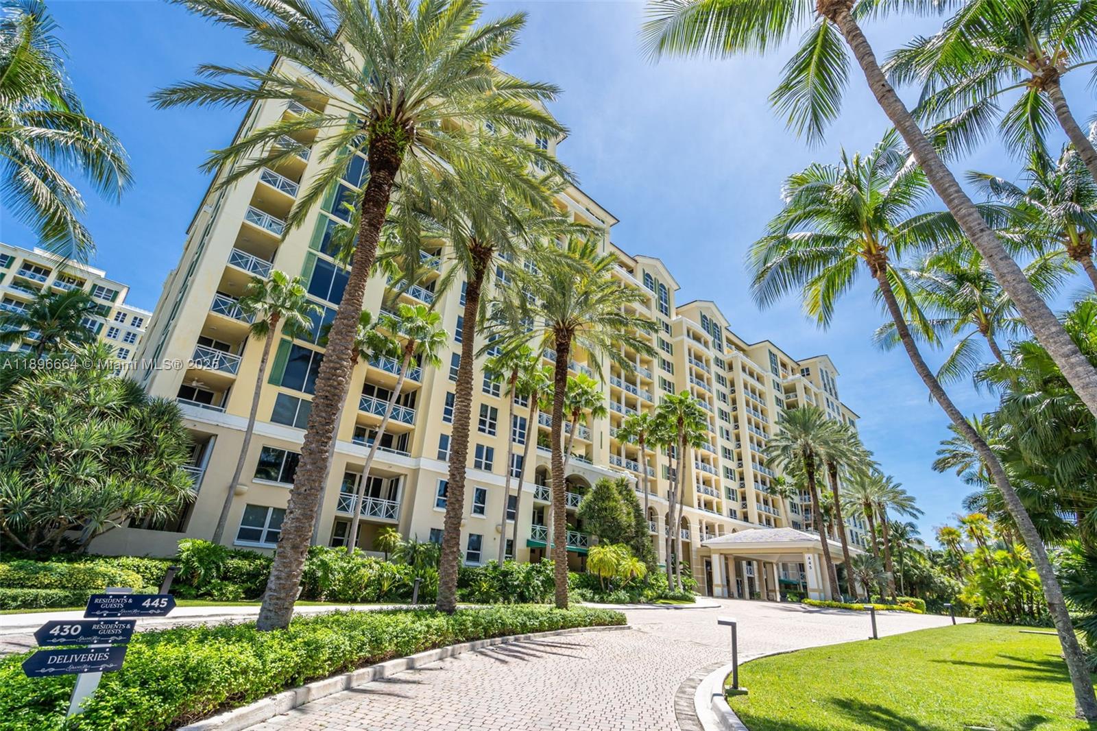 A multi-story residential building with palm trees and a paved driveway in front — 445 Grand Bay Dr # 1001, Key Biscayne FL 33149, KEY BISCAYNE, FL