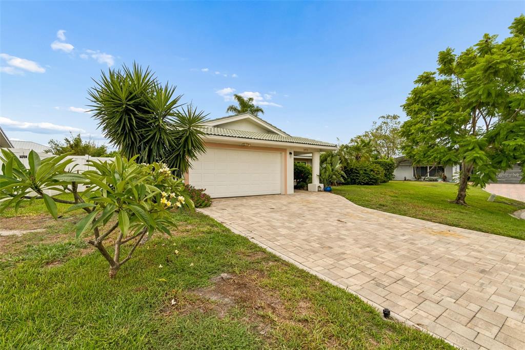 A single-story house with a white garage door and a paved driveway — 1473 50TH AVENUE NE, ST PETERSBURG, FL