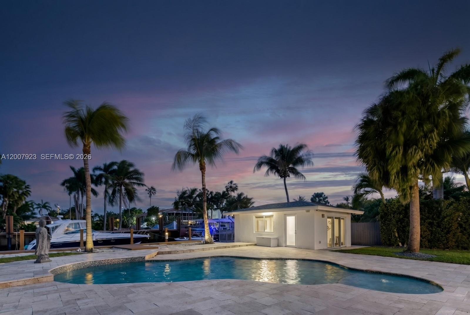 A swimming pool sits on a stone patio in front of a small white building — 1090 NE 84th St, Miami FL 33138, MIAMI, FL