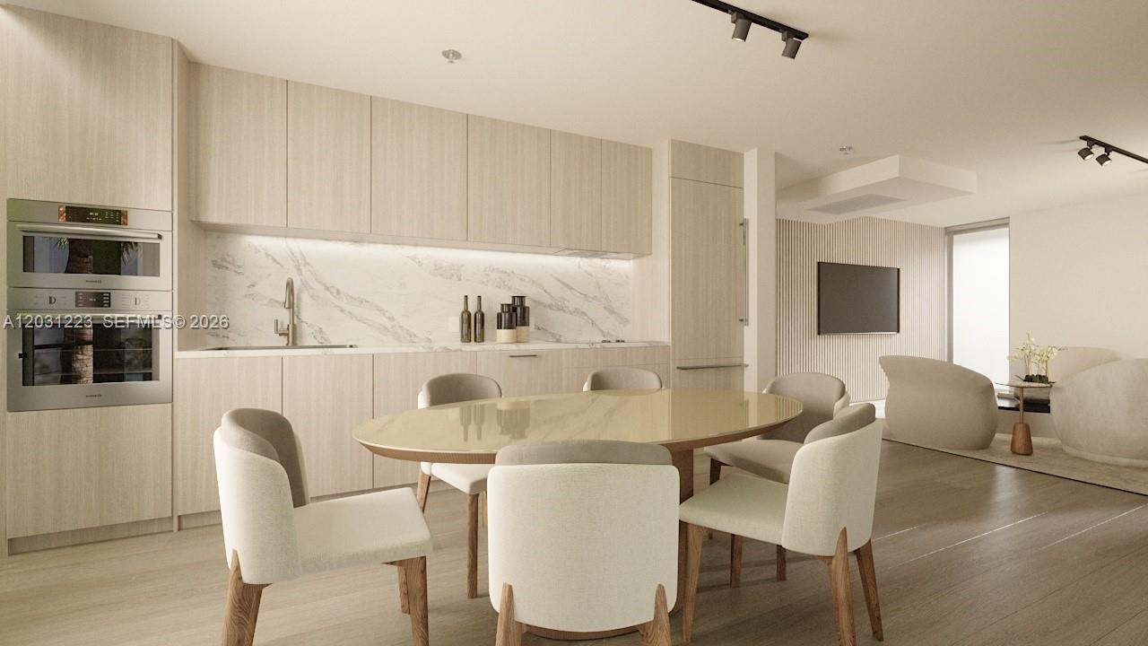 This is a rendering of a modern kitchen and dining area with light wood cabinetry — 260 Collins Ave # 303, Miami Beach FL 33139, MIAMI BEACH, FL