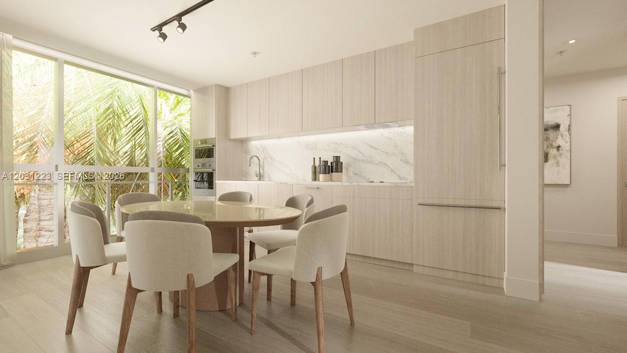 This rendering shows a modern kitchen and dining area with light wood cabinetry and marble — 260 Collins Ave # 303, Miami Beach FL 33139, MIAMI BEACH, FL