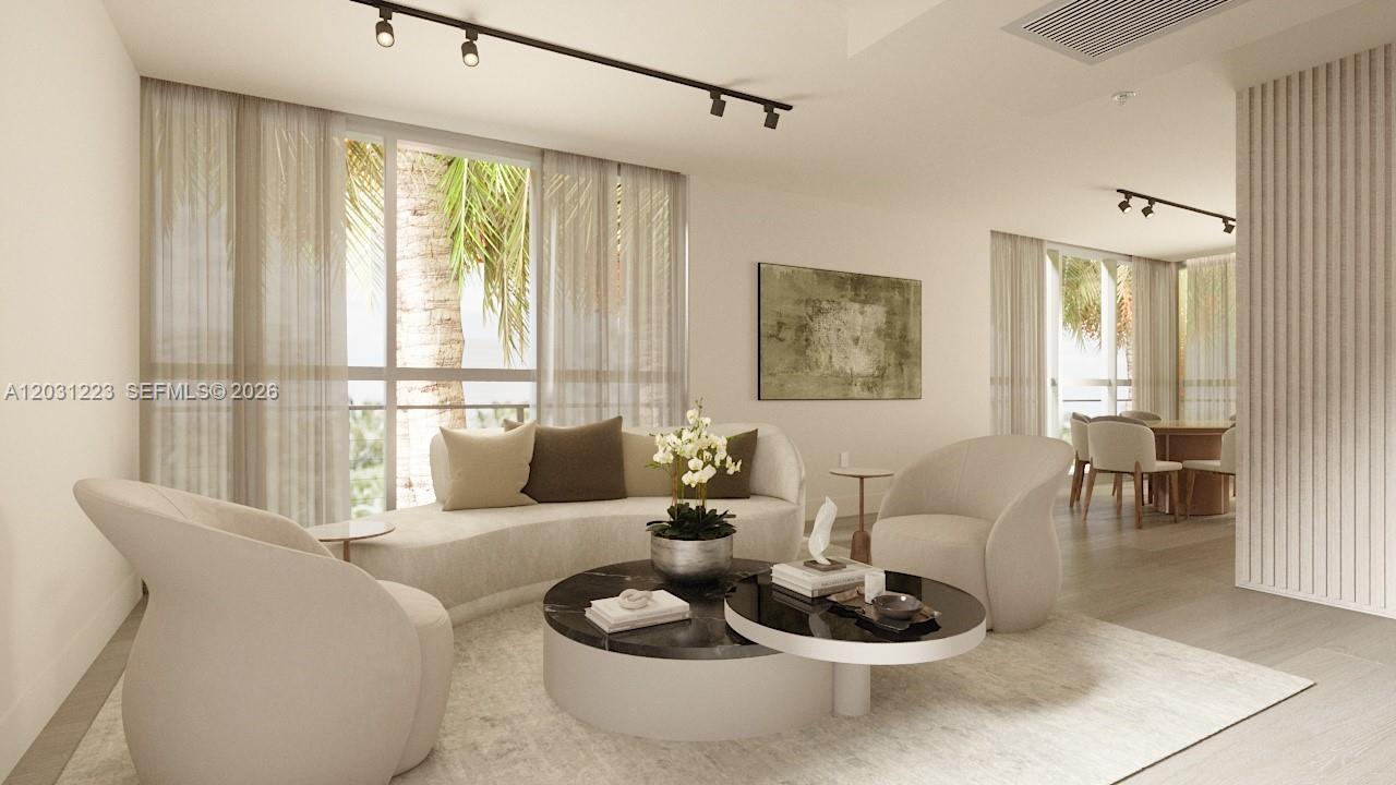 This is a rendering of a modern living room featuring curved furniture and floor-to-ceiling windows — 260 Collins Ave # 303, Miami Beach FL 33139, MIAMI BEACH, FL