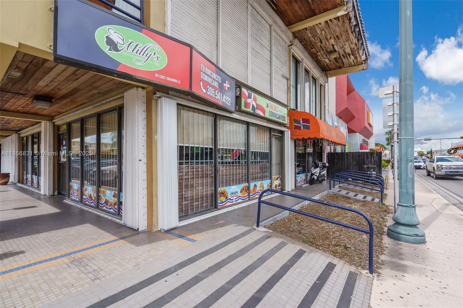 The exterior of a commercial building features a restaurant storefront with signage and metal railings — 2742 SW 8th St, Miami FL 33135, MIAMI, FL
