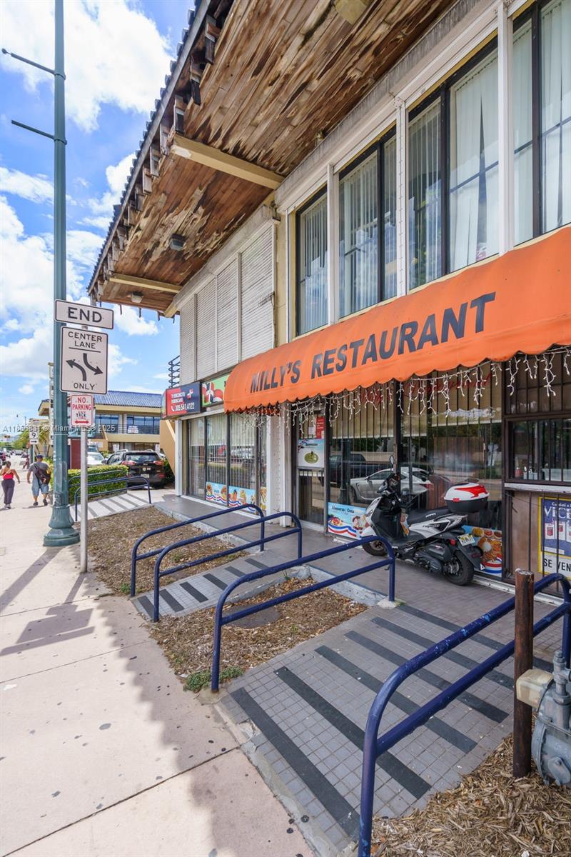 A street-level view of Milly's Restaurant with an orange awning and a parked scooter — 2742 SW 8th St, Miami FL 33135, MIAMI, FL