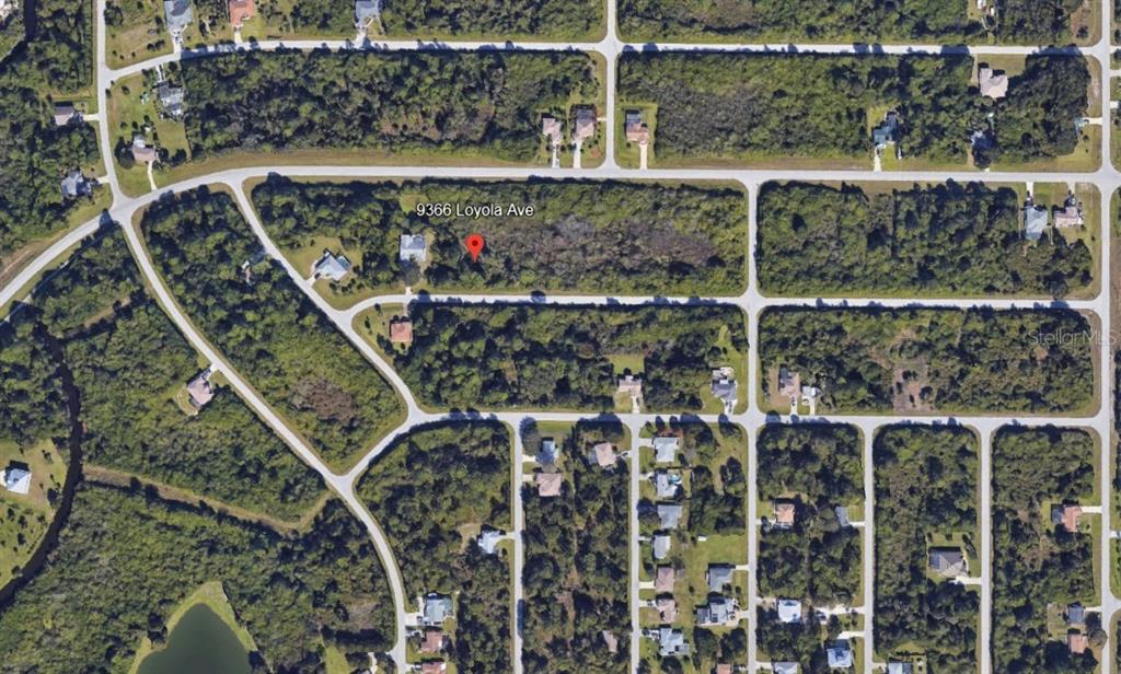 This is an aerial map view of a vacant residential lot surrounded by wooded areas — 9366 LOYOLA AVENUE, ENGLEWOOD, FL