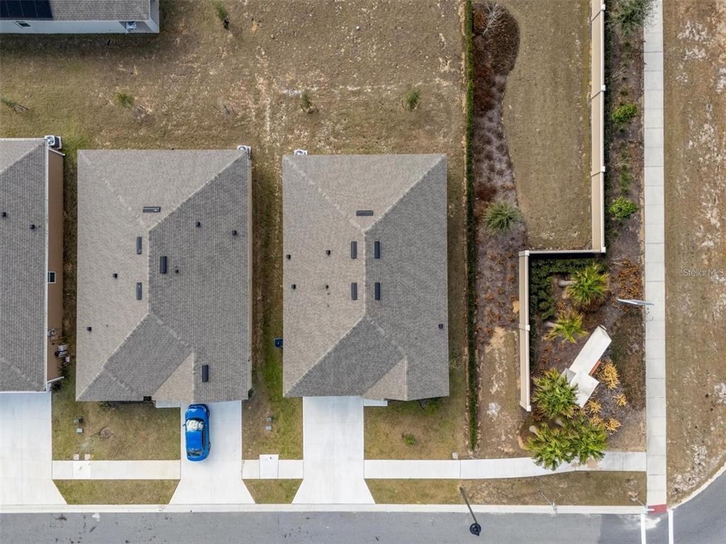 An aerial view shows two suburban houses with gray roofs and driveways next to landscaping — 2006 DOE RUN DRIVE, DAVENPORT, FL