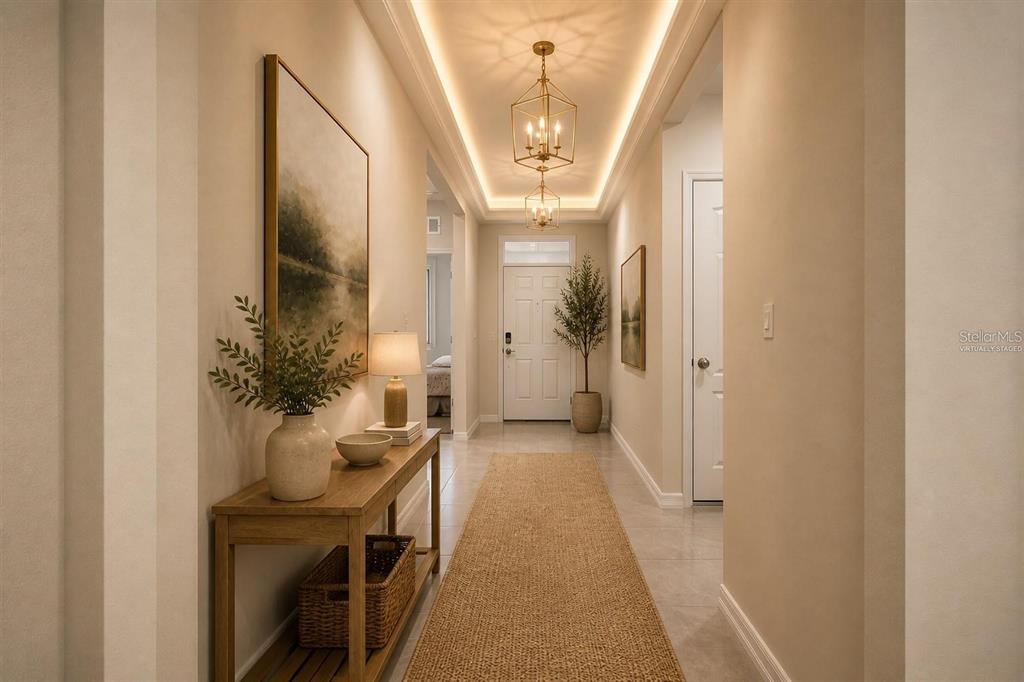 A bright, neutrally colored hallway features a console table, a runner rug, and pendant lighting — 2006 DOE RUN DRIVE, DAVENPORT, FL