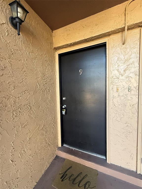 A black apartment door marked with the number nine features a digital keypad lock — 1575 GREENLEA DRIVE UNIT 9, CLEARWATER, FL