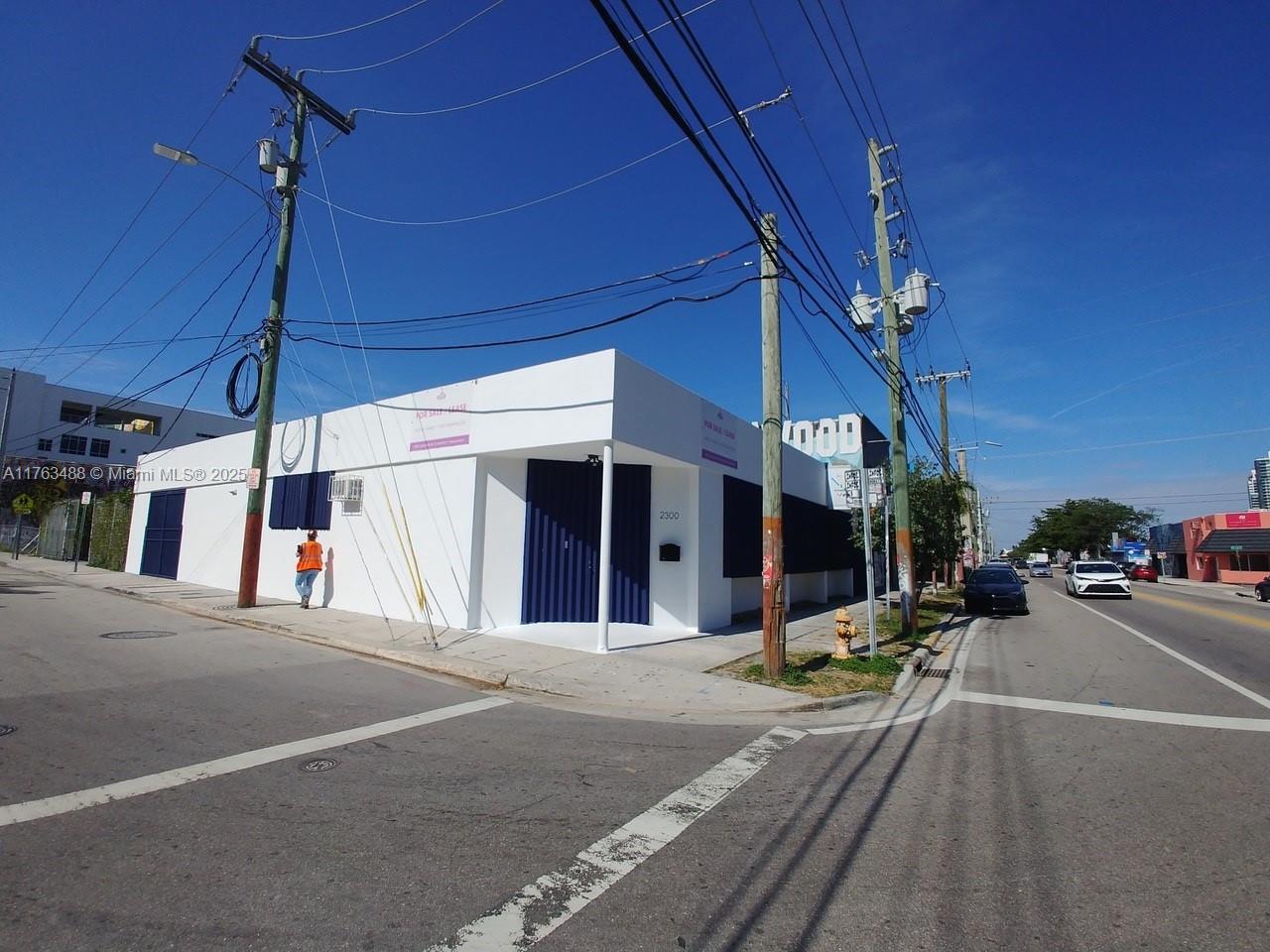 A white commercial building with blue doors and windows sits on a street corner — 2300 N Miami Ave, Miami FL 33127, MIAMI, FL