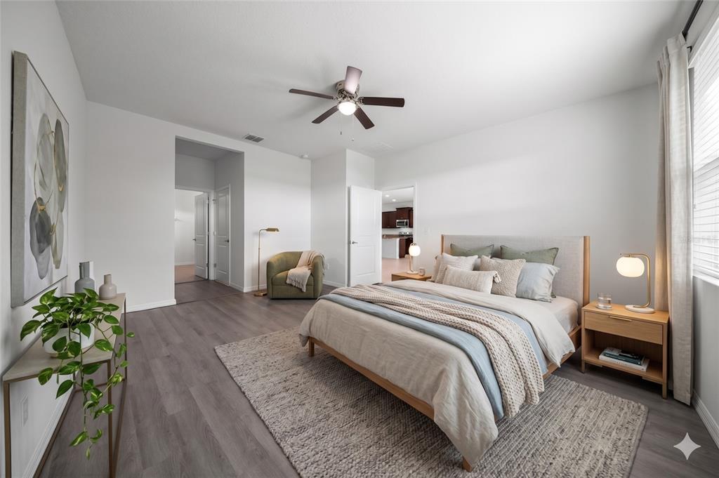 A bedroom features light wood furniture, a grey area rug, and a ceiling fan — 9139 SW 60TH COURT ROAD, OCALA, FL