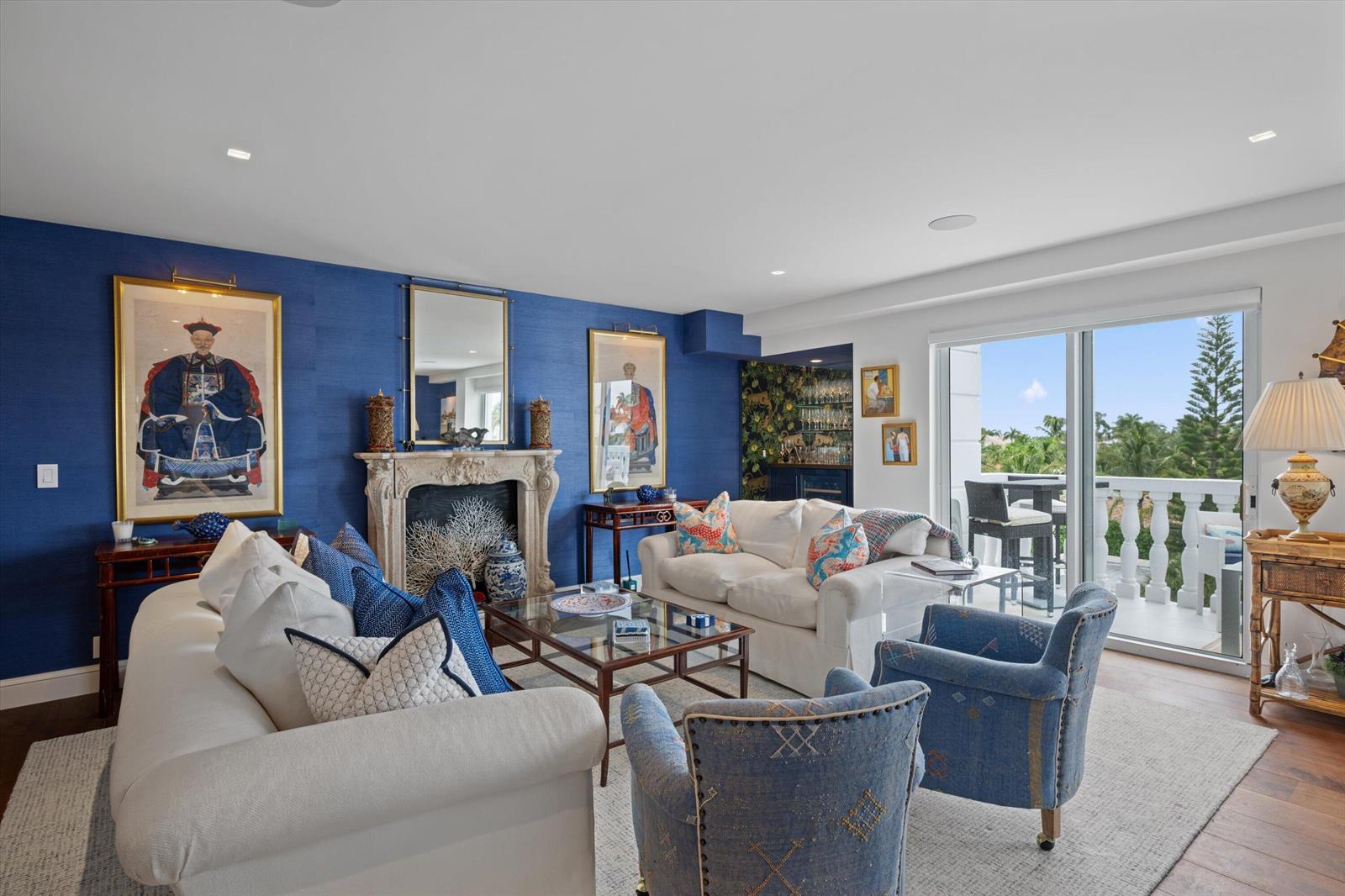 A living room features blue grasscloth walls, a stone fireplace, white sofas, and a balcony — 330 Cocoanut Row # 5b, Palm Beach FL 33480, PALM BEACH, FL