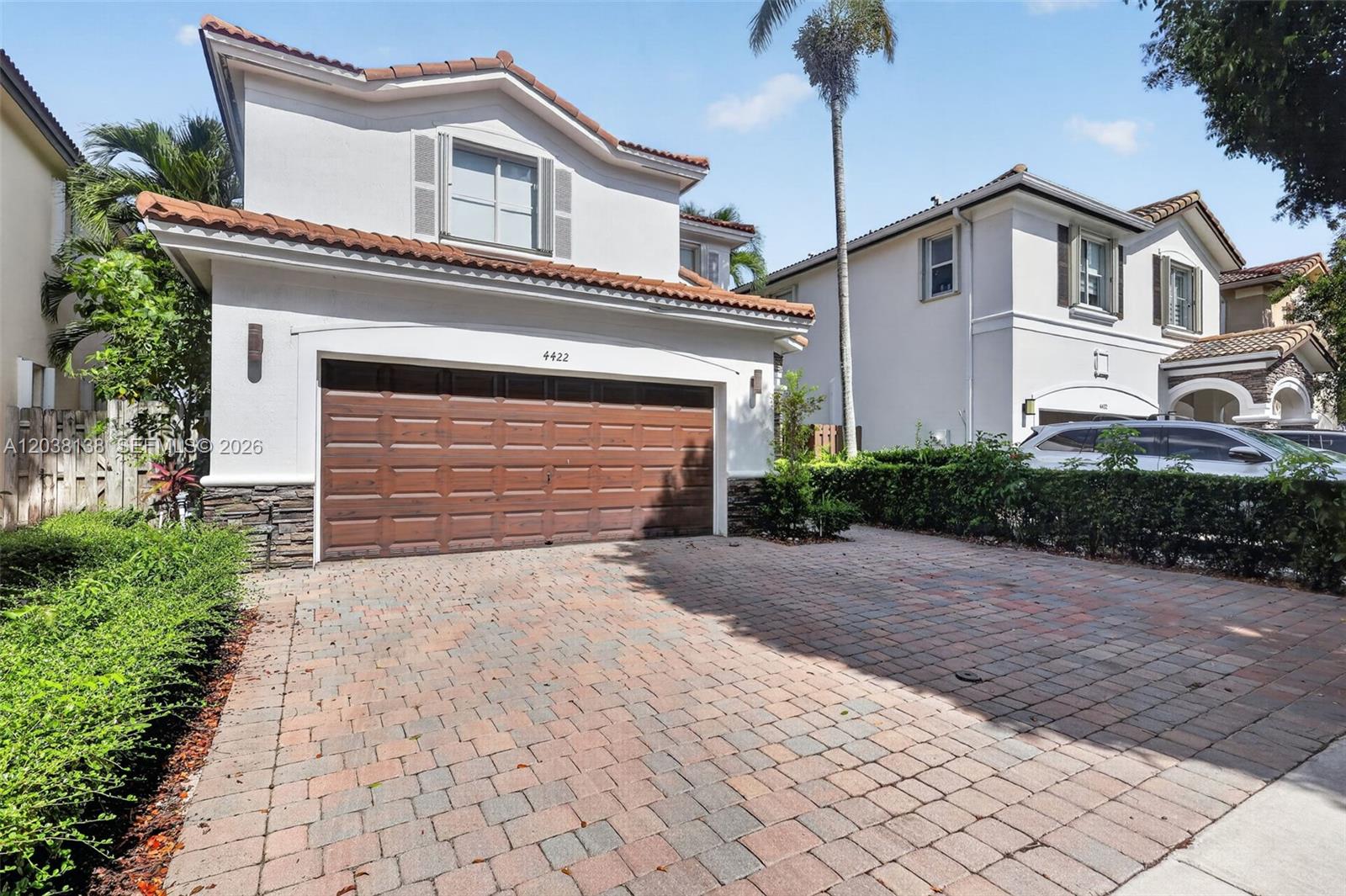 A two-story house with a brown garage door and a brick driveway — 4422 NW 112th Ct, Doral FL 33178, DORAL, FL