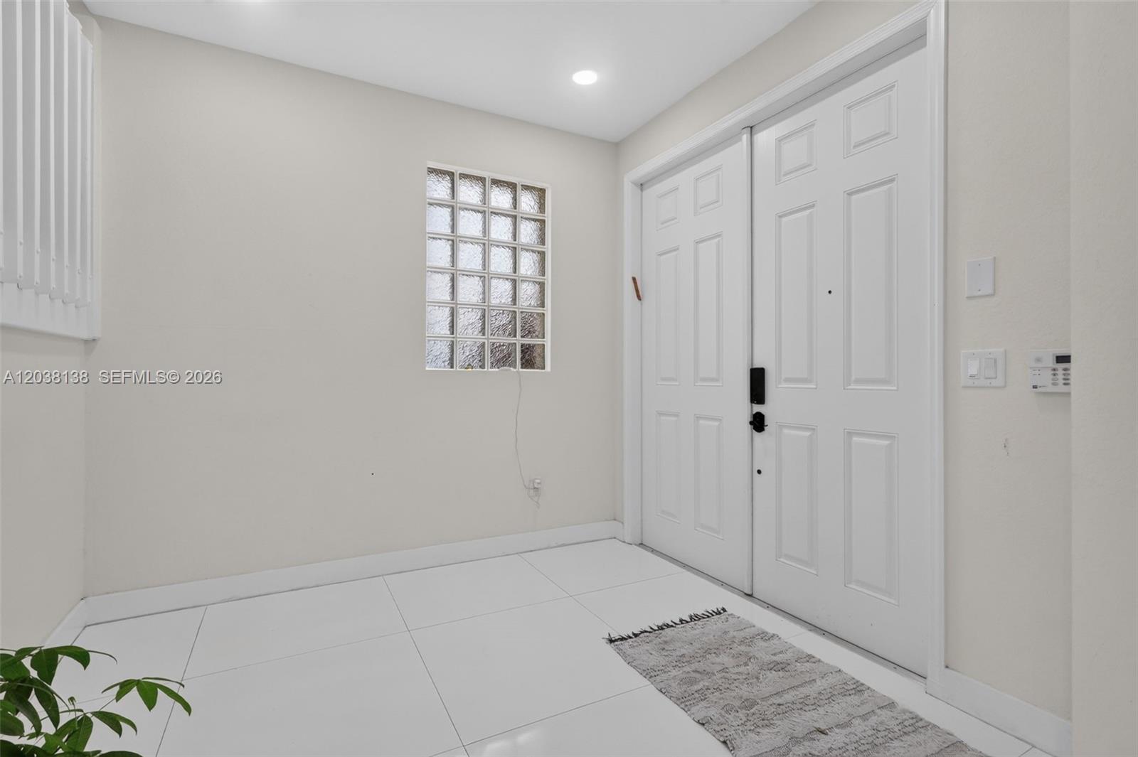 An entryway features white tile flooring, a glass block window, and a double front door — 4422 NW 112th Ct, Doral FL 33178, DORAL, FL