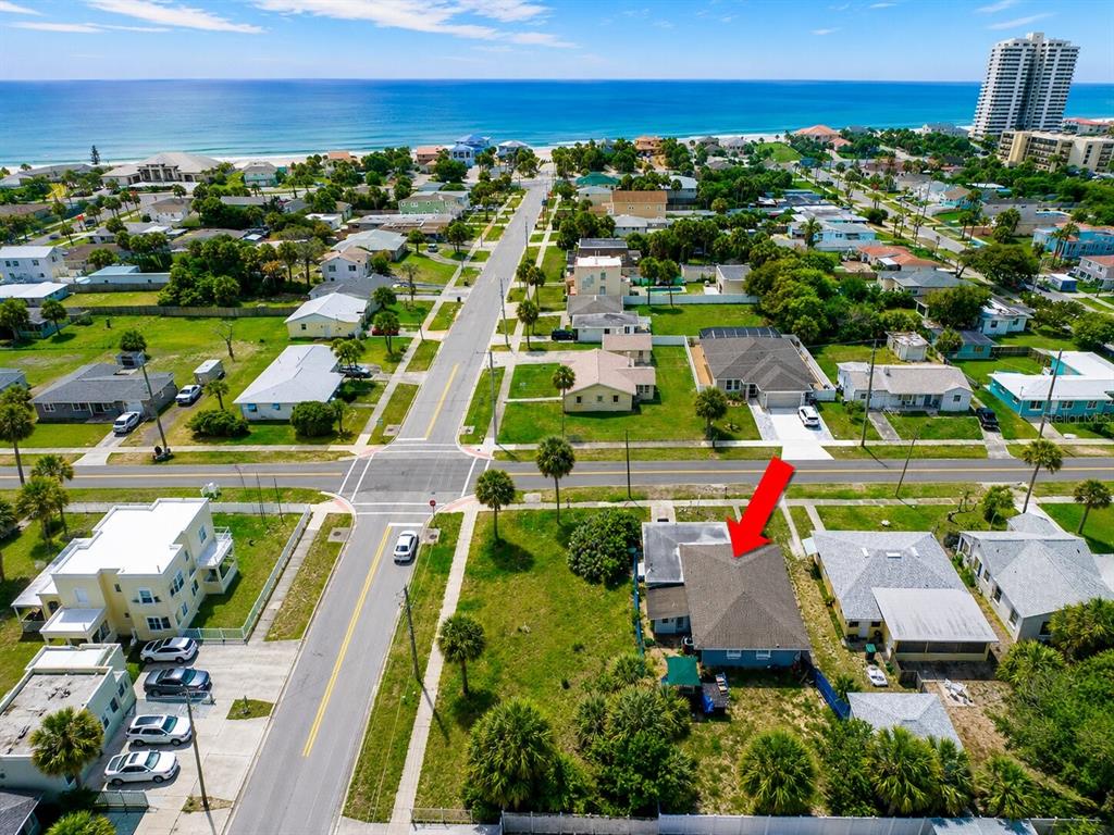 An aerial view shows a residential neighborhood near the ocean with a house highlighted — 1517 N GRANDVIEW AVENUE, DAYTONA BEACH, FL