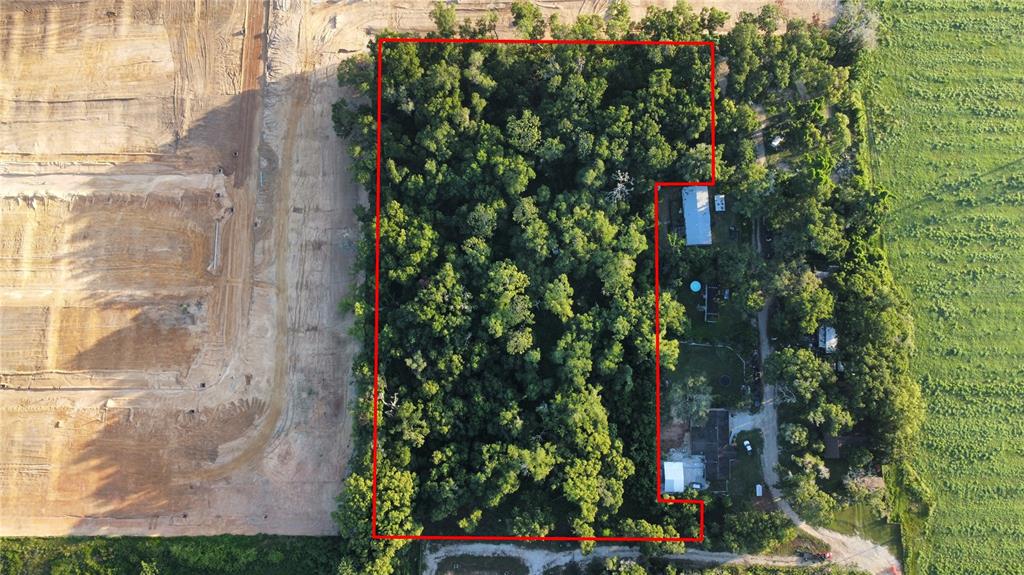An aerial view shows a wooded lot outlined in red next to a construction site — SKYLINE DRIVE, DADE CITY, FL