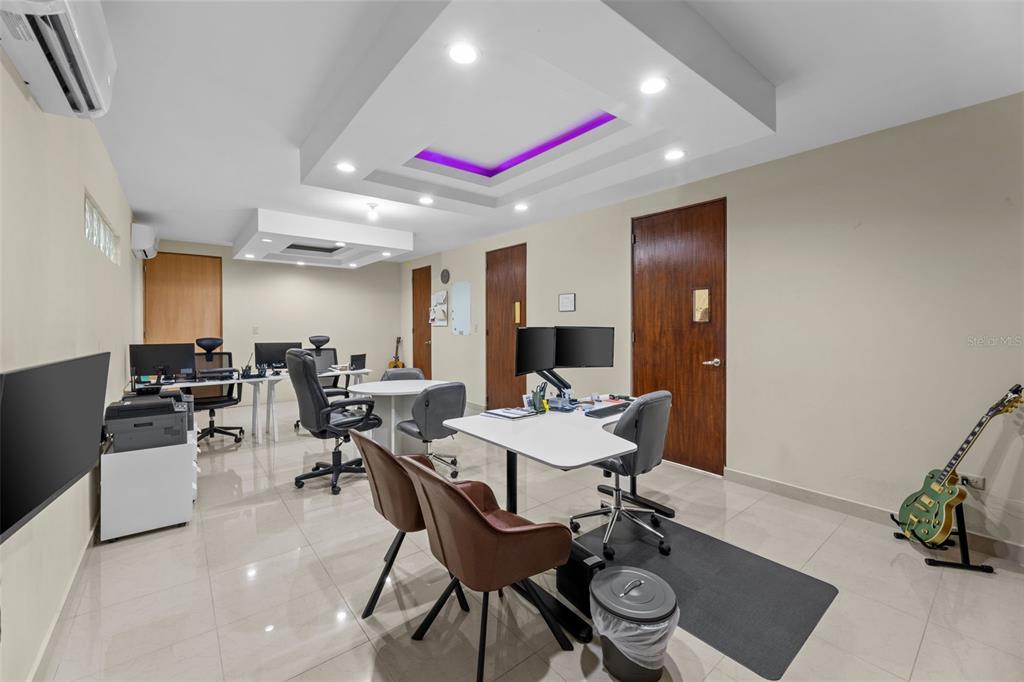 A modern office space features multiple desks, chairs, tile flooring, and a recessed ceiling light — 152 C. NÚÑEZ ROMERO UNIT 152, CAYEY, PR