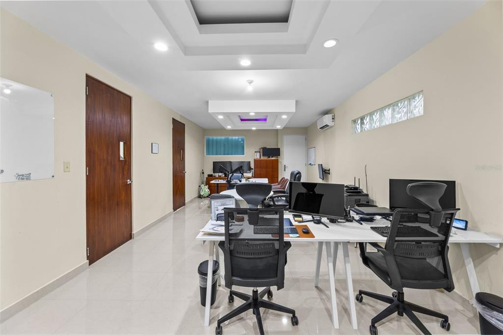 A modern office space features white desks, black ergonomic chairs, and a recessed tray ceiling — 152 C. NÚÑEZ ROMERO UNIT 152, CAYEY, PR
