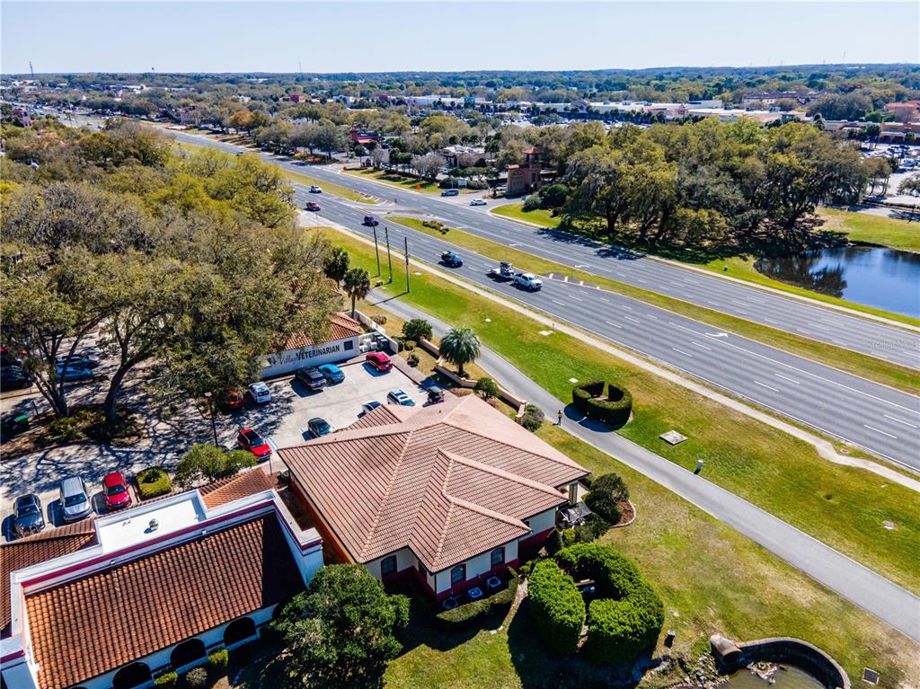 An aerial view shows a veterinary clinic with a parking lot next to a highway — 309 LAGRANDE BOULEVARD, LADY LAKE, FL