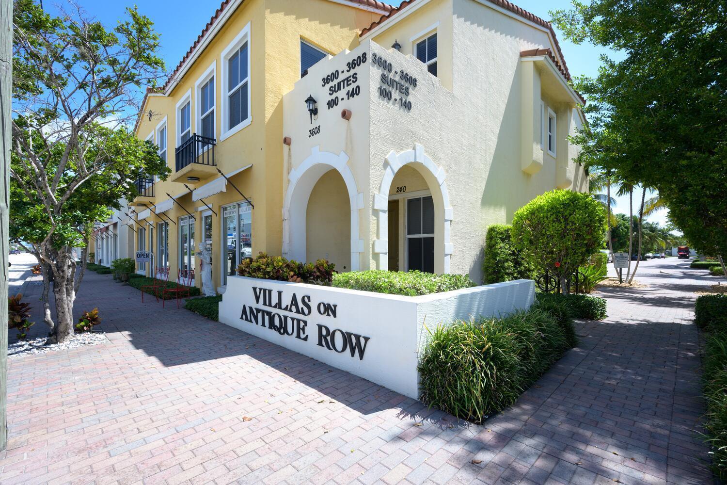 A two-story yellow stucco commercial building with arched entryways and a brick sidewalk — 3604 S Dixie Highway # 120, West Palm Beach FL 33405, WEST PALM BEACH, FL