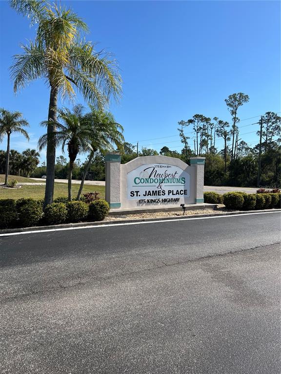 A sign for Newport Condominiums and St. James Place stands near palm trees and pavement — 175 KINGS HIGHWAY UNIT A8, PUNTA GORDA, FL