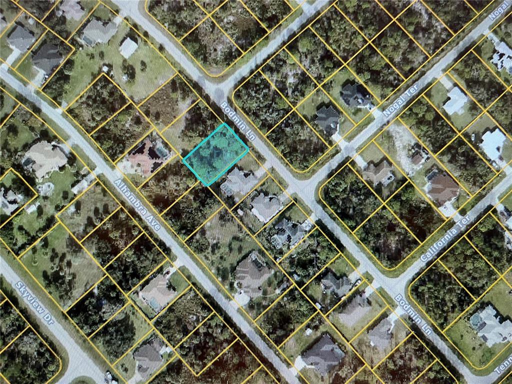 This is an aerial map showing a highlighted vacant residential lot at a street intersection — LOT 10 BODMAN LANE, NORTH PORT, FL