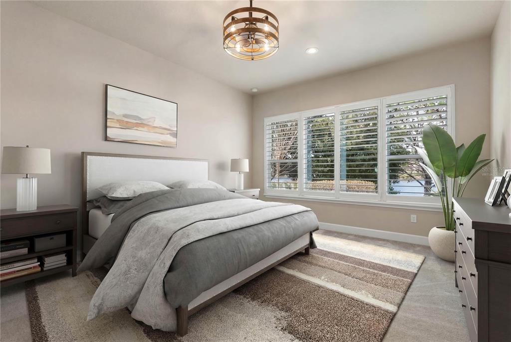 A bedroom features a bed, a dresser, a rug, and windows with white plantation shutters — 661 MAHOGANY RUN, PALM COAST, FL