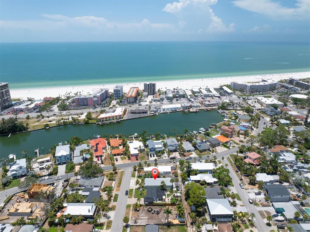 An aerial view shows a coastal neighborhood with a red location pin on a house — 150 42ND AVENUE, ST PETE BEACH, FL