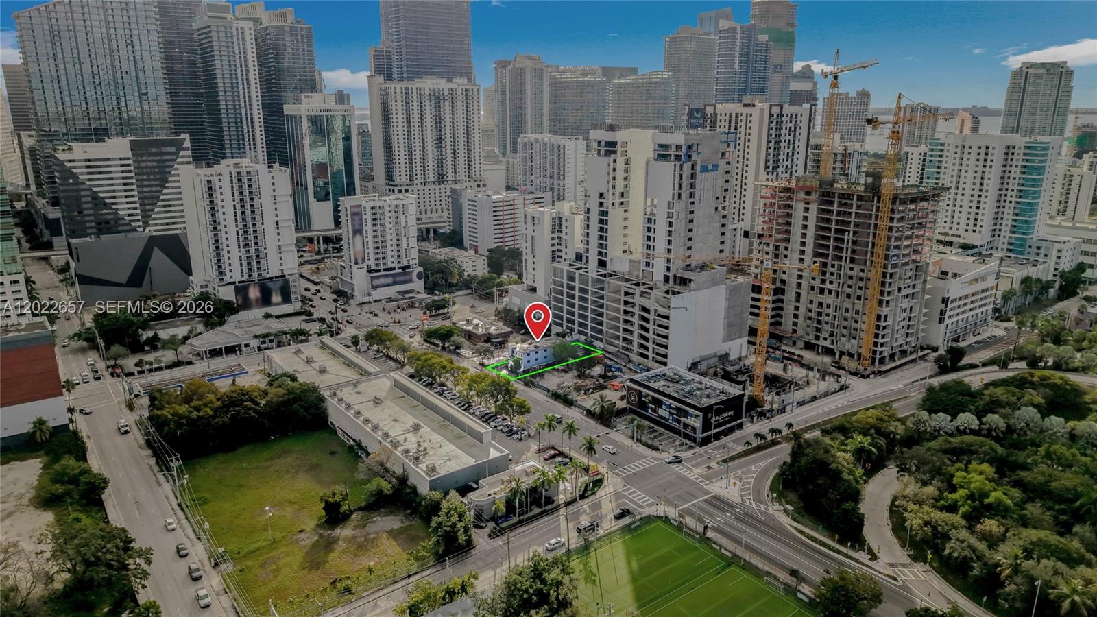 An aerial view shows a small building marked with a pin amidst urban construction sites — 232 SW 8th St, Miami FL 33130, MIAMI, FL