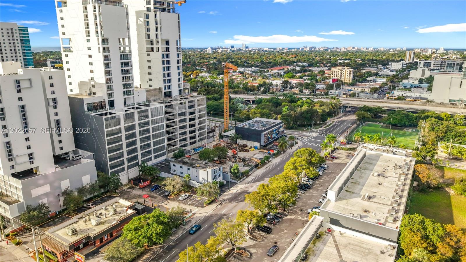 An aerial view shows high-rise buildings, a construction site with a crane, and surrounding streets — 232 SW 8th St, Miami FL 33130, MIAMI, FL