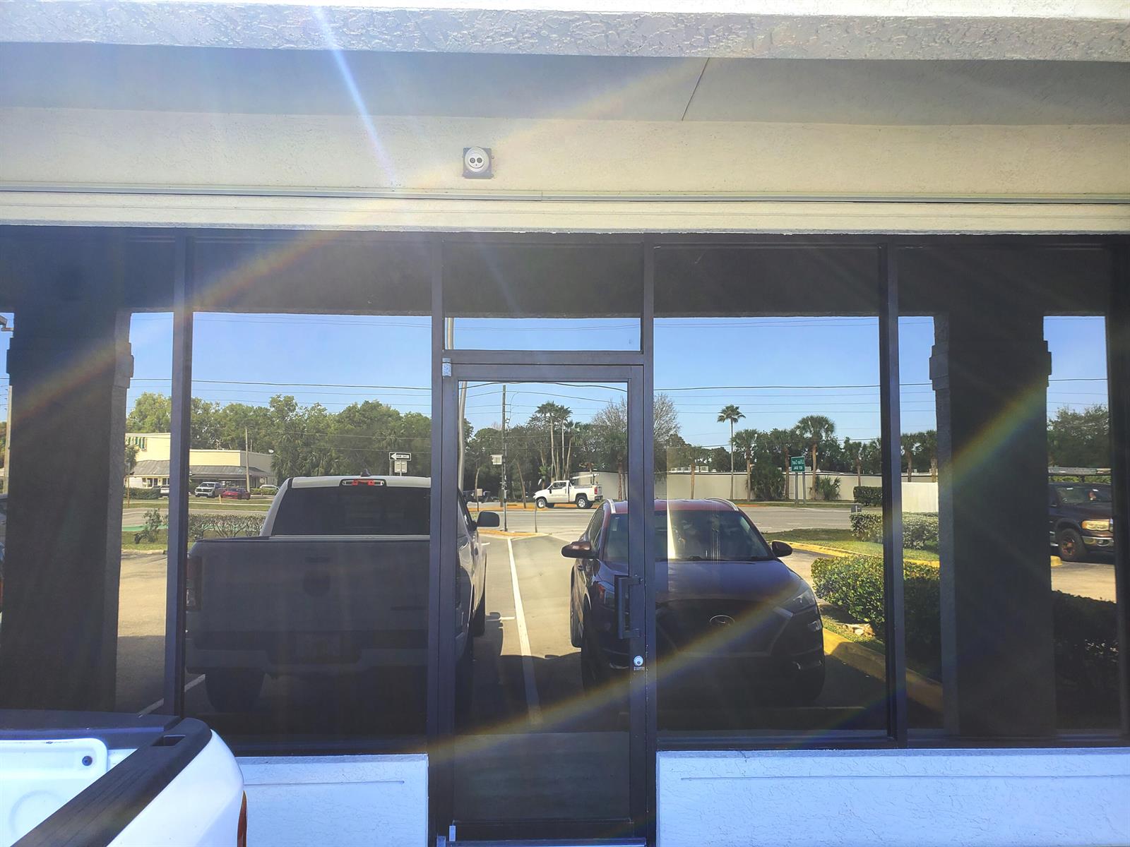 The exterior view shows a glass storefront door and windows reflecting a parking lot — 6366 SE Federal Highway # 6378a, Stuart FL 34997, STUART, FL