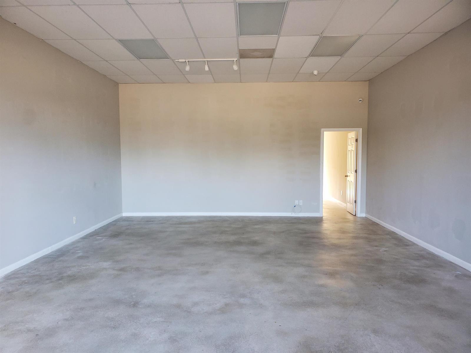 An empty commercial space features gray walls, a drop ceiling, and a concrete floor — 6366 SE Federal Highway # 6378a, Stuart FL 34997, STUART, FL