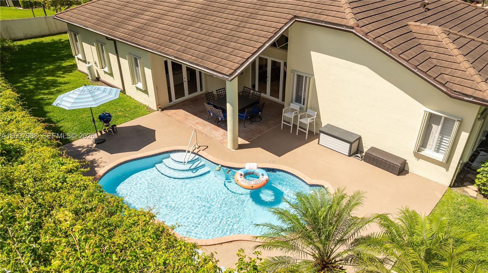 An aerial view shows a house with a tiled roof, patio, and swimming pool — 14831 SW 95th Ct, Miami FL 33176, MIAMI, FL